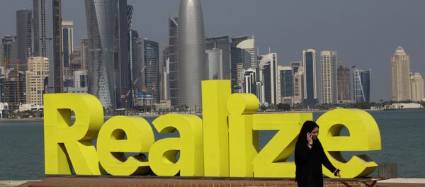 A women walks at the corniche seaside, in Doha, Qatar, on Sunday Jan. 23, 2011. A women walks at the corniche seaside, in Doha, Qatar, on Sunday Jan. 23, 2011. - Sputnik International