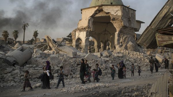 Fleeing Iraqi civilians walk past the heavily damaged al-Nuri mosque as Iraqi forces continue their advance against Islamic State militants in the Old City of Mosul, Iraq, Tuesday, July 4, 2017 Fleeing Iraqi civilians walk past the heavily damaged al-Nuri mosque as Iraqi forces continue their advance against Islamic State militants in the Old City of Mosul, Iraq, Tuesday, July 4, 2017 - Sputnik International