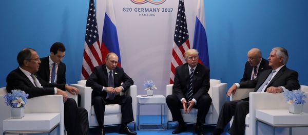 Russia's President Vladimir Putin sits next to U.S. President Donald Trump during their bilateral meeting at the G20 summit in Hamburg, Germany July 7, 2017 - Sputnik International