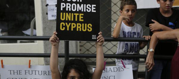 A girl hold up a board with a peace massage during a peace protest at Ladras or Lokmachi crossing point that connects the Greek Cypriot south and the Turkish Cypriots breakaway north, inside the U.N buffer zone in central divided capital , Nicosia, Cyprus, Thursday, July 6, 2017. A girl hold up a board with a peace massage during a peace protest at Ladras or Lokmachi crossing point that connects the Greek Cypriot south and the Turkish Cypriots breakaway north, inside the U.N buffer zone in central divided capital , Nicosia, Cyprus, Thursday, July 6, 2017. - Sputnik International