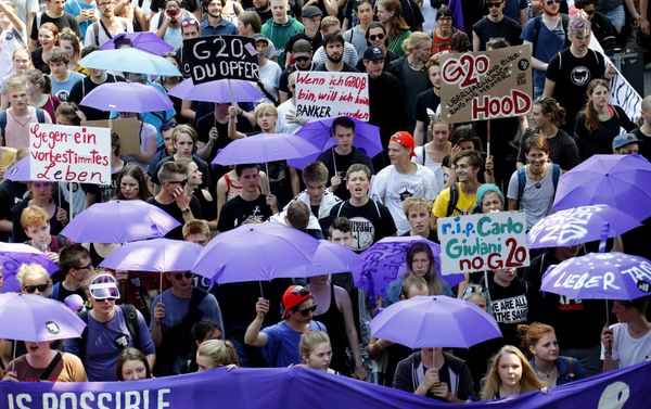 People hold banners and umbrellas as they walk during the protest demonstration at the G20 summit in Hamburg, Germany, July 7, 2017 People hold banners and umbrellas as they walk during the protest demonstration at the G20 summit in Hamburg, Germany, July 7, 2017 - Sputnik International