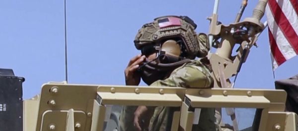 This Saturday, April. 29, 2017 still taken from video, shows an American soldier looking out of an armored vehicle in the northern village of Darbasiyah, Syria - Sputnik International