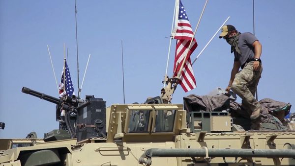 This Saturday, April. 29, 2017 still taken from video, shows an American soldier standing on an armored vehicle in the northern village of Darbasiyah, Syria - Sputnik International