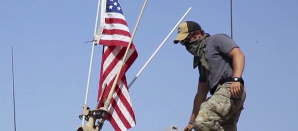 This Saturday, April. 29, 2017 still taken from video, shows an American soldier standing on an armored vehicle in the northern village of Darbasiyah, Syria This Saturday, April. 29, 2017 still taken from video, shows an American soldier standing on an armored vehicle in the northern village of Darbasiyah, Syria - Sputnik International