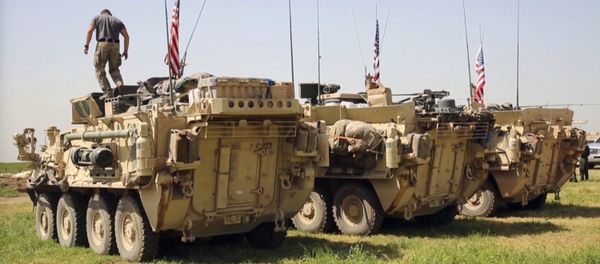 This Saturday, April. 29, 2017 still taken from video, shows an American soldier standing on an armored vehicle in the northern village of Darbasiyah, Syria. U.S - Sputnik International