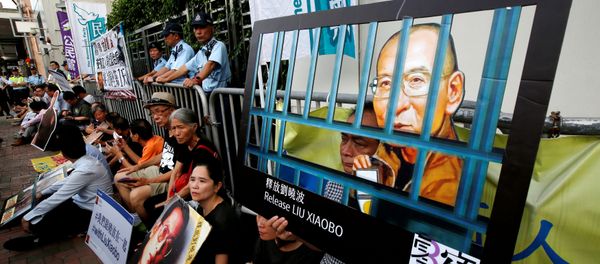 Pro-democracy activists stage a sit-in protest demanding the release of Nobel laureate Liu Xiaobo, outside China's Liaison Office in Hong Kong, China July 10, 2017. - Sputnik International