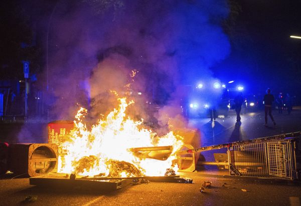 Policemen stand behind a burning barricade in the so-called 'Schanzenviertel' area, on the sidelines of the G-20 summit, early Sunday, July 9, 2017, in Hamburg.  - Sputnik International