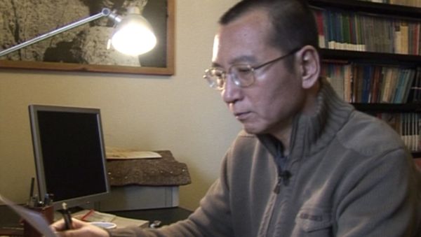 In this image taken from Jan 6, 2008, video footage by AP Video, Liu Xiaobo looks at documents in his home in Beijing, China. - Sputnik International