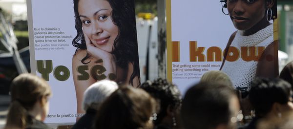 Public service posters in English and Spanish are seen at a news conference to announce a Los Angeles County program to provide young women in South Los Angeles with home-testing kits for sexually transmitted diseases, at a news conference in the Watts-Willowbrook area of Los Angeles Monday, Sept. 19, 2011. - Sputnik International
