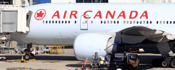An Air Canada Boeing 777 sits at a gate after it was forced to return to Sydney Airport in Sydney, Thursday, July 28, 2011, after crew members saw smoke coming from an oven in the galley. No one on Flight AC34 was injured in the incident, which forced the pilot to dump fuel before safely landing. - Sputnik International