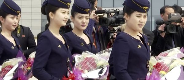 In this image taken from video, Air Koryo cabin crew wait with flowers on tarmac for the airline's first flight from Dandong, at Sunan airport in Pyongyang, North Korea Tuesday, March 28, 2017. In this image taken from video, Air Koryo cabin crew wait with flowers on tarmac for the airline's first flight from Dandong, at Sunan airport in Pyongyang, North Korea Tuesday, March 28, 2017. - Sputnik International