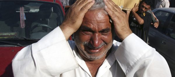 A man weeps for Saad Mozan, 42, who was killed in an overnight raid by US troops in the Shiite stronghold of Sadr City in Baghdad, Iraq on Monday, Sept. 24, 2007. - Sputnik International