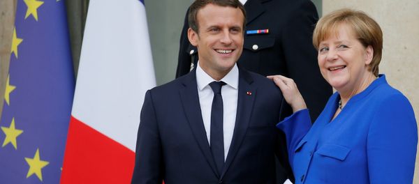 French President Emmanuel Macron (L) accompanies German Chancellor Angela Merkel following a Franco-German joint cabinet meeting at the Elysee Palace in Paris, France, July 13, 2017. French President Emmanuel Macron (L) accompanies German Chancellor Angela Merkel following a Franco-German joint cabinet meeting at the Elysee Palace in Paris, France, July 13, 2017. - Sputnik International