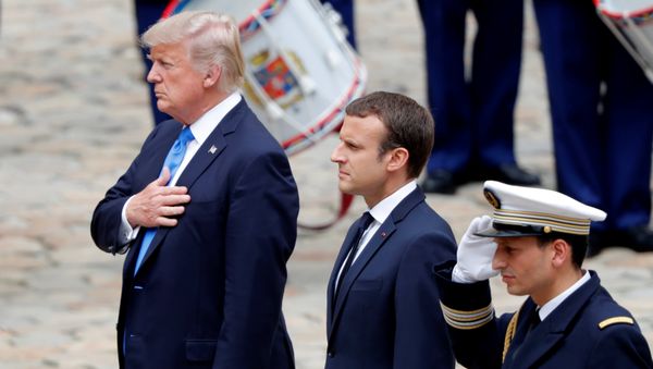 French President Emmanuel Macron and U.S. President Donald Trump listen to national anthems during a welcoming ceremony at the Invalides in Paris, France, July 13, 2017. French President Emmanuel Macron and U.S. President Donald Trump listen to national anthems during a welcoming ceremony at the Invalides in Paris, France, July 13, 2017. - Sputnik International