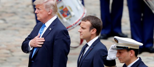 French President Emmanuel Macron and U.S. President Donald Trump listen to national anthems during a welcoming ceremony at the Invalides in Paris, France, July 13, 2017. French President Emmanuel Macron and U.S. President Donald Trump listen to national anthems during a welcoming ceremony at the Invalides in Paris, France, July 13, 2017. - Sputnik International