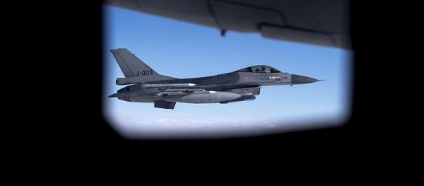 Seen through the window of another aircraft, an Royal Netherlands Air Force F- 16 military fighter jet participating in NATO's Baltic Air Policing Mission operates in Lithuanian airspace during a Ramstein Alloy air force exercise, Tuesday, April 25, 2017 - Sputnik International