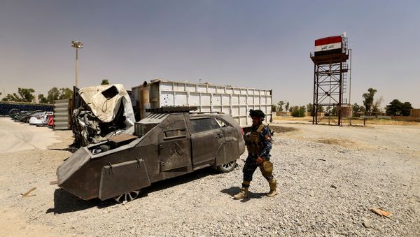 A member of Federal Police walks near vehicles used for suicide car bombings, made by Islamic State militants, at Federal Police Headquarters after being confiscated in Mosul, Iraq July 13, 2017 - Sputnik International