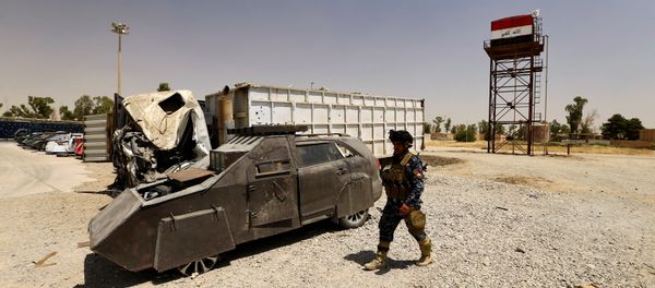 A member of Federal Police walks near vehicles used for suicide car bombings, made by Islamic State militants, at Federal Police Headquarters after being confiscated in Mosul, Iraq July 13, 2017 - Sputnik International
