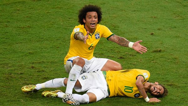 Brazil's defender Marcelo (back) reacts over Brazil's forward Neymar after he was injured following a tackle during the quarter-final football match between Brazil and Colombia at the Castelao Stadium in Fortaleza during the 2014 FIFA World Cup on July 4, 2014. - Sputnik International