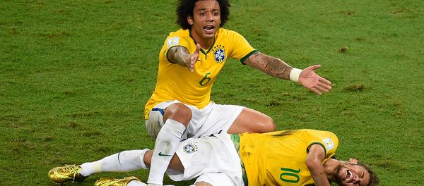 Brazil's defender Marcelo (back) reacts over Brazil's forward Neymar after he was injured following a tackle during the quarter-final football match between Brazil and Colombia at the Castelao Stadium in Fortaleza during the 2014 FIFA World Cup on July 4, 2014. - Sputnik International