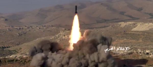 This frame grab from video released on Saturday, July 22, 2017 and provided by the government-controlled Syrian Central Military Media, shows Hezbollah fighters firing a missile at positions of al-Qaida-linked militants in an area on the Lebanon-Syria border - Sputnik International