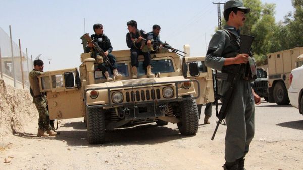Afghan security personnel sit on atop an armoured vehicles amid an ongoing battle with Taliban militants in the Gereshk district of Helmand province on July 22, 2017 - Sputnik International