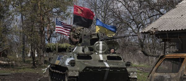 Ukrainian servicemen ride in an armored vehicle, with Ukrainian and U.S. flags and nationalist group Right Sector flag, near a destroyed car in Shyrokyne, eastern Ukraine, Wednesday, April 15, 2015 Ukrainian servicemen ride in an armored vehicle, with Ukrainian and U.S. flags and nationalist group Right Sector flag, near a destroyed car in Shyrokyne, eastern Ukraine, Wednesday, April 15, 2015 - Sputnik International