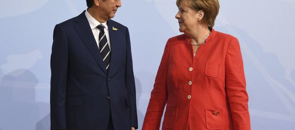 German chancellor Angela Merkel welcomes Japan's Prime Minister Shinzo Abe at the start of the G-20 meeting in Hamburg, northern Germany, on Friday, July 7, 2017. German chancellor Angela Merkel welcomes Japan's Prime Minister Shinzo Abe at the start of the G-20 meeting in Hamburg, northern Germany, on Friday, July 7, 2017. - Sputnik International