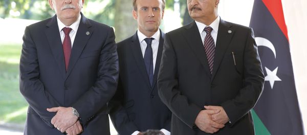 Libya's Prime Minister Fayez al-Sarraj of the U.N.-backed government, left, France's President Emmanuel Macron, center, and General Khalifa Hifter of the Egyptian-backed commander of Libya's self-styled national army shake hands listen to France's President Emmanuel Macron after a declaration at the Chateau of the La Celle-Saint-Cloud, west of Paris, France, Tuesday, July 25, 2017. - Sputnik International