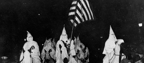In this September 21, 1923 file photo, members of the Ku Klux Klan ride horses during a parade through the streets of Tulsa, Okla. - Sputnik International