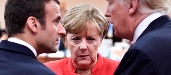 French President Emmanuel Macron, German Chancellor Angela Merkel and US President Donald Trump confer at the start of the first working session of the G20 meeting in Hamburg, Germany, July 7, 2017. - Sputnik International