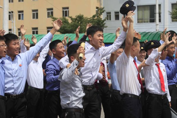 People react while watching a news broadcast on a missile launch in Pyongyang, North Korea, Saturday, July 29, 2017. - Sputnik International