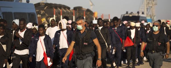 Italian border police officers escort sub Saharan men on their way to a relocation center, after arriving in the Golfo Azzurro rescue vessel at the port of Augusta, in Sicily, Italy, with hundreds of migrants aboard, rescued by members of Proactive Open Arms NGO, on Friday, June 23, 2017 Italian border police officers escort sub Saharan men on their way to a relocation center, after arriving in the Golfo Azzurro rescue vessel at the port of Augusta, in Sicily, Italy, with hundreds of migrants aboard, rescued by members of Proactive Open Arms NGO, on Friday, June 23, 2017 - Sputnik International