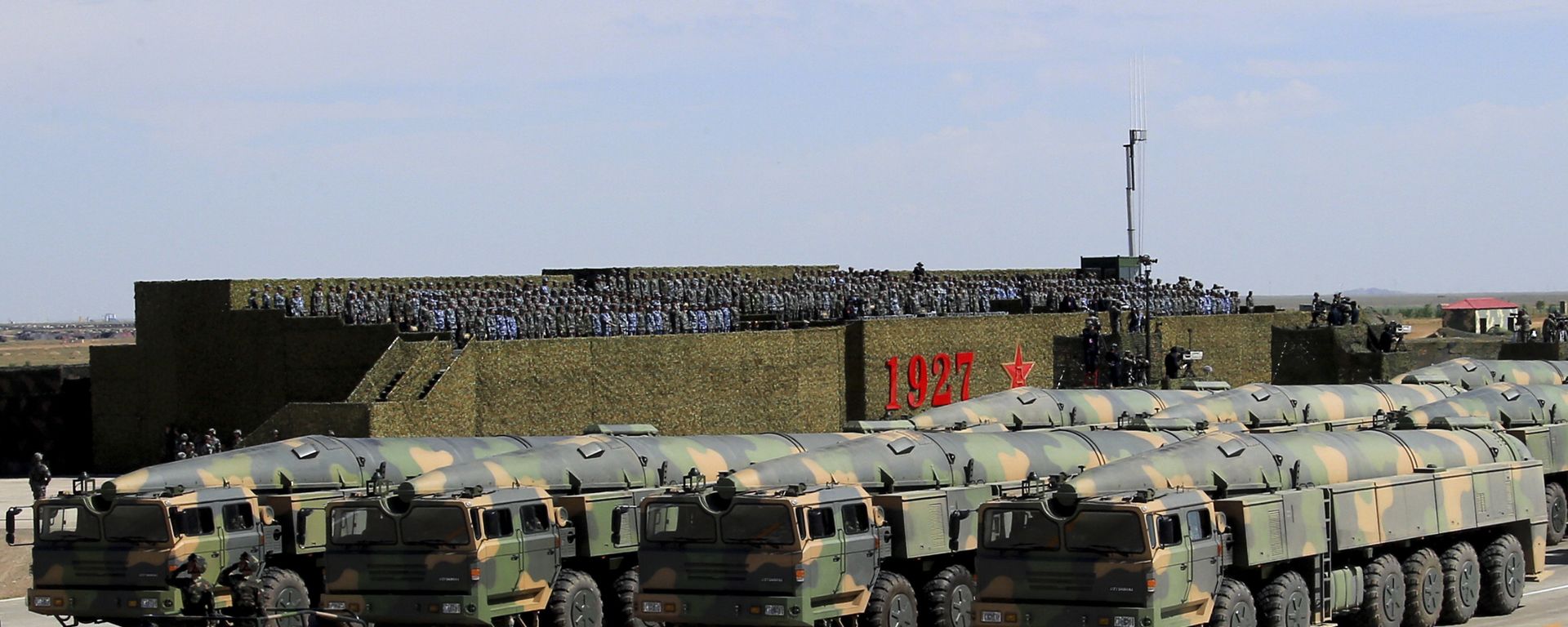 In this photo released by China's Xinhua News Agency, military vehicles carrying missiles for both nuclear and conventional strikes are driven past the VIP stage during a military parade to commemorate the 90th anniversary of the founding of the People's Liberation Army at Zhurihe training base in north China's Inner Mongolia Autonomous Region, Sunday, July 30, 2017 - Sputnik International, 1920, 06.04.2022