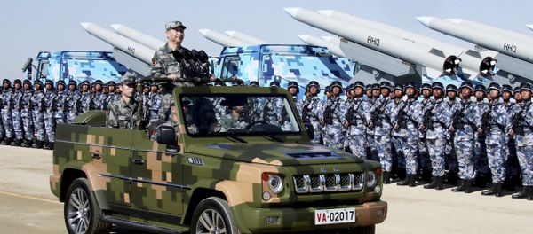 In this photo released by Xinhua News Agency, Chinese President Xi Jinping stands on a military jeep as he inspects troops of the People's Liberation Army during a military parade to commemorate the 90th anniversary of the founding of the PLA at Zhurihe training base in north China's Inner Mongolia Autonomous Region, Sunday, July 30, 2017 In this photo released by Xinhua News Agency, Chinese President Xi Jinping stands on a military jeep as he inspects troops of the People's Liberation Army during a military parade to commemorate the 90th anniversary of the founding of the PLA at Zhurihe training base in north China's Inner Mongolia Autonomous Region, Sunday, July 30, 2017 - Sputnik International