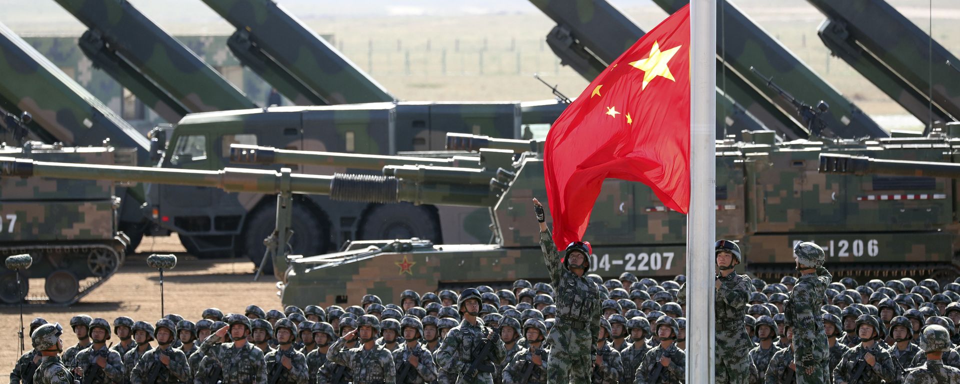 In this photo released by China's Xinhua News Agency, Chinese People's Liberation Army (PLA) troops perform a flag raising ceremony Sunday, July 30, 2017 for a military parade to commemorate the 90th anniversary of the founding of the PLA on Aug. 1 at Zhurihe training base in north China's Inner Mongolia Autonomous Region - Sputnik International, 1920, 06.03.2023