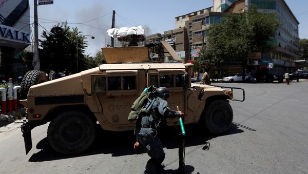An Afghan police man covers himself as smoke rises from the site of an attack in Kabul, Afghanistan July 31, 2017 An Afghan police man covers himself as smoke rises from the site of an attack in Kabul, Afghanistan July 31, 2017 - Sputnik International