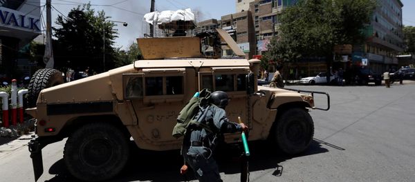 An Afghan police man covers himself as smoke rises from the site of an attack in Kabul, Afghanistan July 31, 2017 An Afghan police man covers himself as smoke rises from the site of an attack in Kabul, Afghanistan July 31, 2017 - Sputnik International