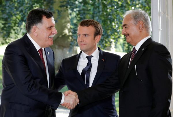 French President Emmanuel Macron stands between Libyan Prime Minister Fayez al-Sarraj (L), and General Khalifa Haftar (R), commander in the Libyan National Army (LNA), who shake hands after talks over a political deal to help end Libya’s crisis in La Celle-Saint-Cloud near Paris, France, July 25, 2017 French President Emmanuel Macron stands between Libyan Prime Minister Fayez al-Sarraj (L), and General Khalifa Haftar (R), commander in the Libyan National Army (LNA), who shake hands after talks over a political deal to help end Libya’s crisis in La Celle-Saint-Cloud near Paris, France, July 25, 2017 - Sputnik International