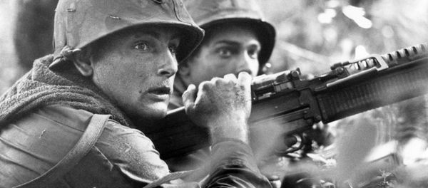 U.S. machine gunner Spc. 4 James R. Pointer, left, of Cedartown, Ga., and Pfc. Herald Spracklen of Effingham, Ill., peer from the brush of an overgrown rubber plantation near the Special Forces camp at Bu Dop during a half hour firefight, Dec. 5, 1967 U.S. machine gunner Spc. 4 James R. Pointer, left, of Cedartown, Ga., and Pfc. Herald Spracklen of Effingham, Ill., peer from the brush of an overgrown rubber plantation near the Special Forces camp at Bu Dop during a half hour firefight, Dec. 5, 1967 - Sputnik International
