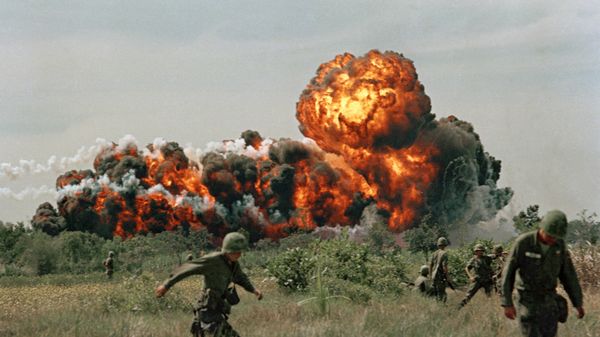 A napalm strike erupts in a fireball near U.S. troops on patrol in South Vietnam, 1966 during the Vietnam War - Sputnik International