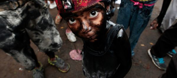 A girl covered in motor oil takes part in the festivities honouring the capital's patron saint Santo Domingo de Guzman in Managua, Nicaragua A girl covered in motor oil takes part in the festivities honouring the capital's patron saint Santo Domingo de Guzman in Managua, Nicaragua - Sputnik International