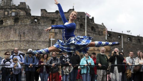 Highland Dancer Elayne Seaton from the Tattoo Dance Company performs on the Edinburgh Castle esplanade after the Royal Edinburgh Military Tattoo programme was revealed by Brigadier David Allfrey, chief executive and producer of the Tattoo, in Edinburgh - Sputnik International