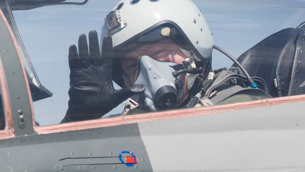 Ukrainian President Petro Poroshenko waves from the cockpit of a MiG-29 fighter jet before taking off from the military airfield in the village of Vasylkiv, outside Kiev, Ukraine - Sputnik International