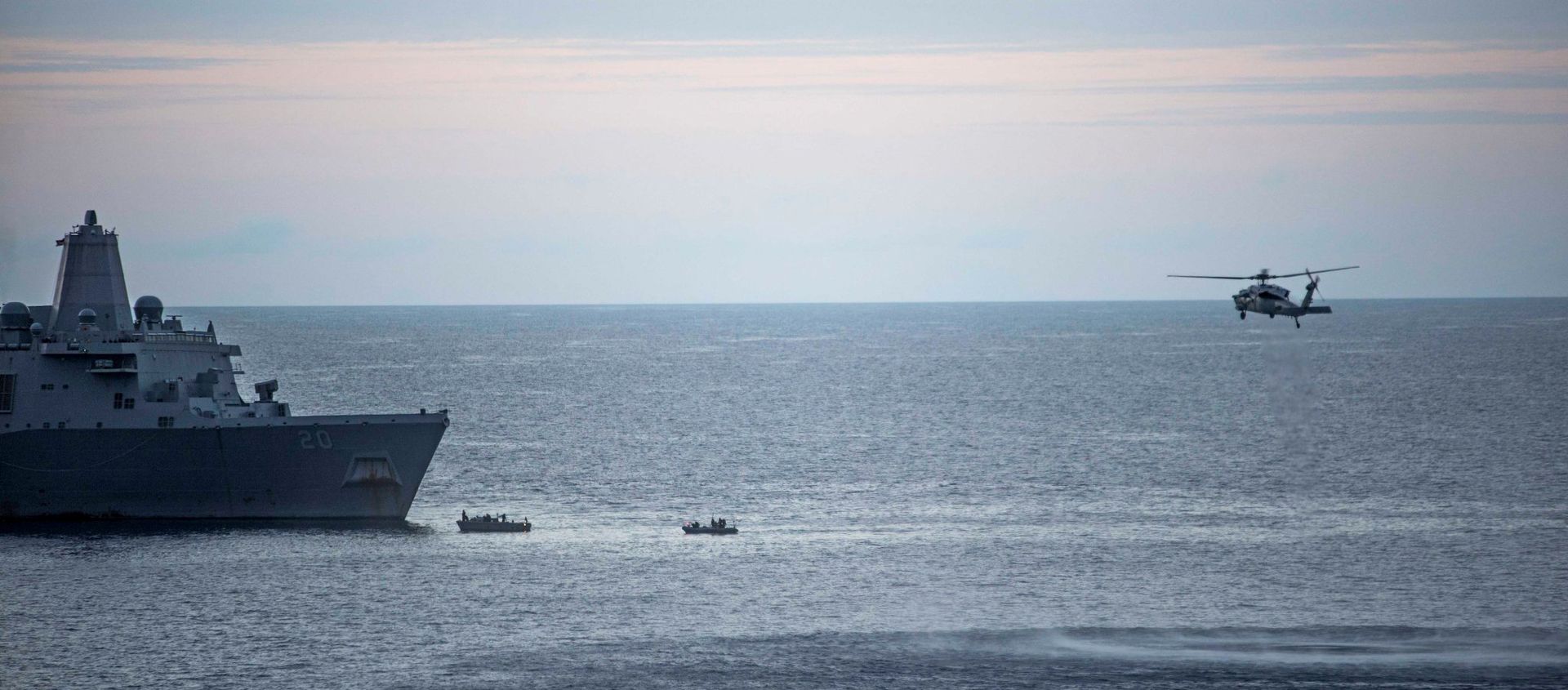 In this Saturday, Aug. 5, 2017, sailors man small boats as an MH-60S Sea Hawk helicopter, assigned to Helicopter Sea Combat Squadron (HSC) 25 flies overhead to recover personnel near the amphibious transport dock USS Green Bay (LPD 20) following an aviation mishap of an MV-22 Osprey, which caused the aircraft to enter the water off the coast of Australia.  - Sputnik International, 1920, 01.04.2021