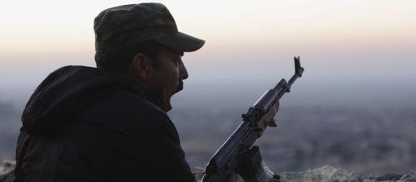 In this Friday, Nov. 13, 2015, file photo, a Kurdish fighter, known as a peshmerga, yawns as he stands guard on the frontline in Sinjar, Iraq In this Friday, Nov. 13, 2015, file photo, a Kurdish fighter, known as a peshmerga, yawns as he stands guard on the frontline in Sinjar, Iraq - Sputnik International