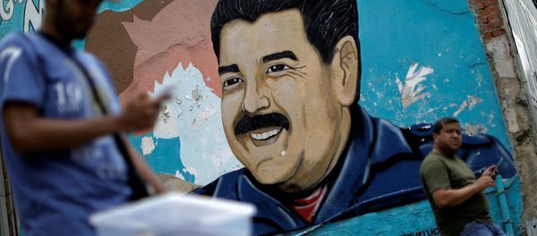 A man walks past a portrait of Venezuela's President Nicolas Maduro in Caracas, Venezuela August 7, 2017. A man walks past a portrait of Venezuela's President Nicolas Maduro in Caracas, Venezuela August 7, 2017. - Sputnik International