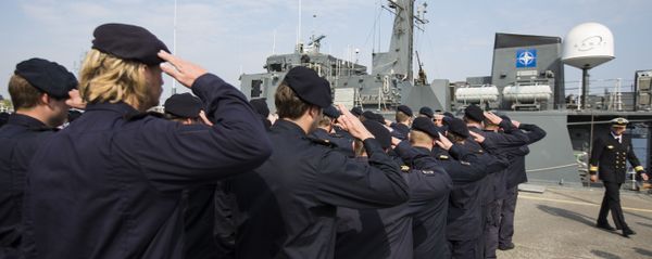 Crew members of Norwegian minesweeper Otra salute after a briefing of NATO Allied Maritime Command Deputy Chief of Staff for Operations, Commodore Arian Minderhoud, right, of the Royal Netherlands Navy before setting sail together in a convoy of five ships of Norway, Belgium, the Netherlands and Estonia from Kiel, Germany, Tuesday, April 22, 2014 Crew members of Norwegian minesweeper Otra salute after a briefing of NATO Allied Maritime Command Deputy Chief of Staff for Operations, Commodore Arian Minderhoud, right, of the Royal Netherlands Navy before setting sail together in a convoy of five ships of Norway, Belgium, the Netherlands and Estonia from Kiel, Germany, Tuesday, April 22, 2014 - Sputnik International