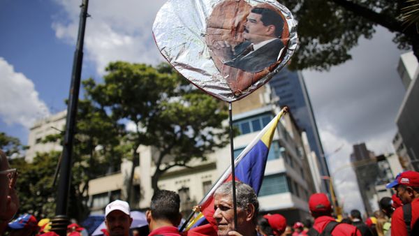 A government supporter holds a heart-shaped placard decorated with an image of Venezuela's Nicolas Maduro during a rally in support of the Constitutional Assembly outside of the National Assembly building in Caracas, Venezuela, Monday, Aug. 7, 2017. A government supporter holds a heart-shaped placard decorated with an image of Venezuela's Nicolas Maduro during a rally in support of the Constitutional Assembly outside of the National Assembly building in Caracas, Venezuela, Monday, Aug. 7, 2017. - Sputnik International