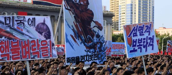 Tens of thousands of North Koreans gathered for a rally at Kim Il Sung Square carrying placards and propaganda slogans as a show of support for their rejection of the United Nations' latest round of sanctions on Wednesday Aug. 9, 2017, in Pyongyang, North Korea Tens of thousands of North Koreans gathered for a rally at Kim Il Sung Square carrying placards and propaganda slogans as a show of support for their rejection of the United Nations' latest round of sanctions on Wednesday Aug. 9, 2017, in Pyongyang, North Korea - Sputnik International